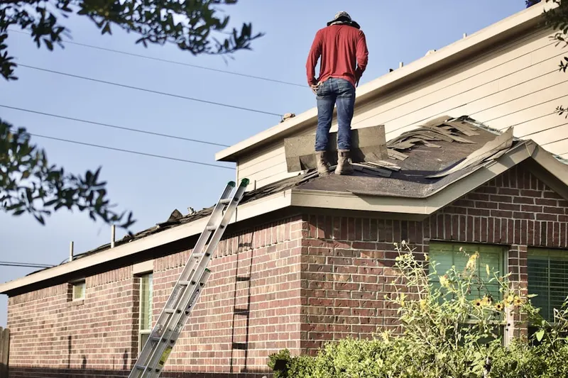 Professional roofer working on a residential roof in South Lowell